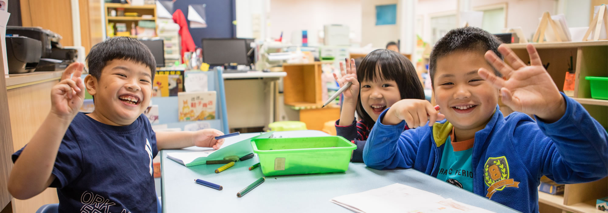 happy kindergarten kids painting waving
